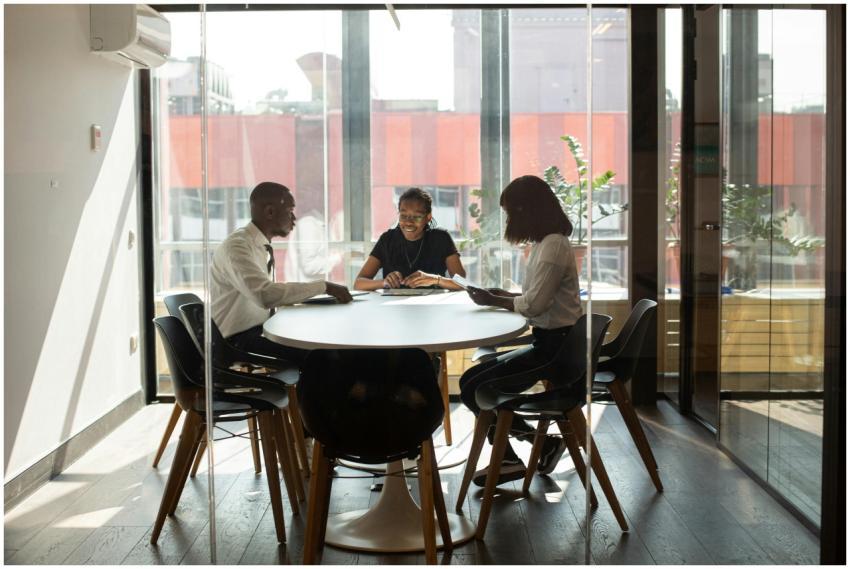 Three professionals collaborating in a modern offi