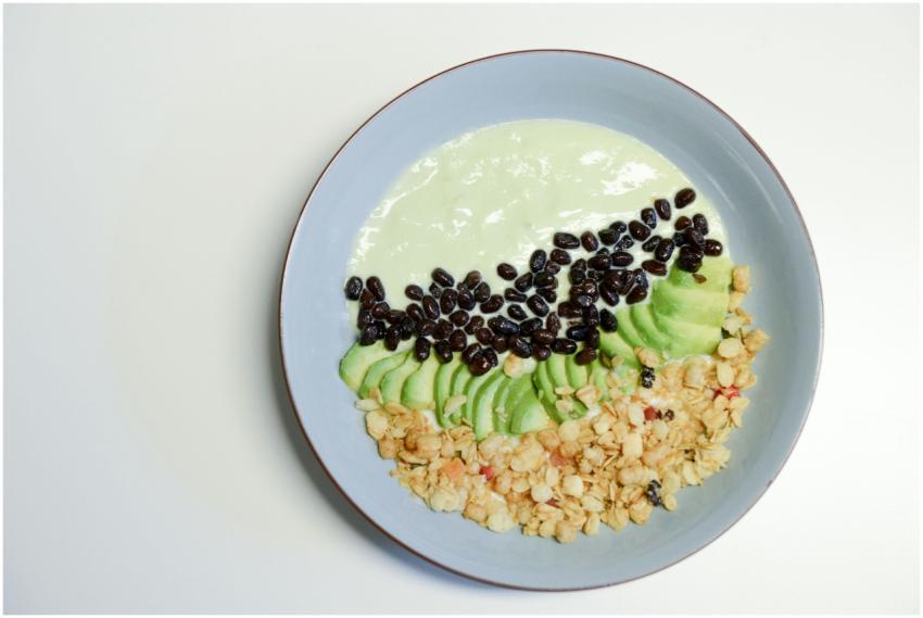 A healthy smoothie bowl featuring avocado, black b