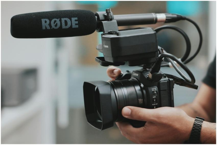 Close-up of hands holding a professional video cam