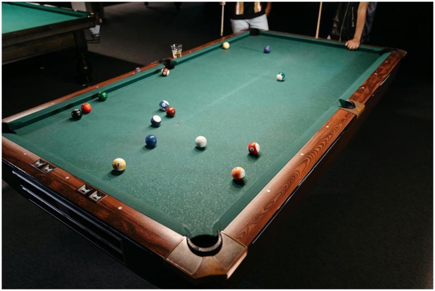 A close-up of a game in progress on a billiard tab