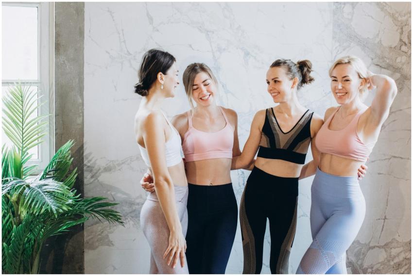 Four women in activewear smiling and enjoying fitn