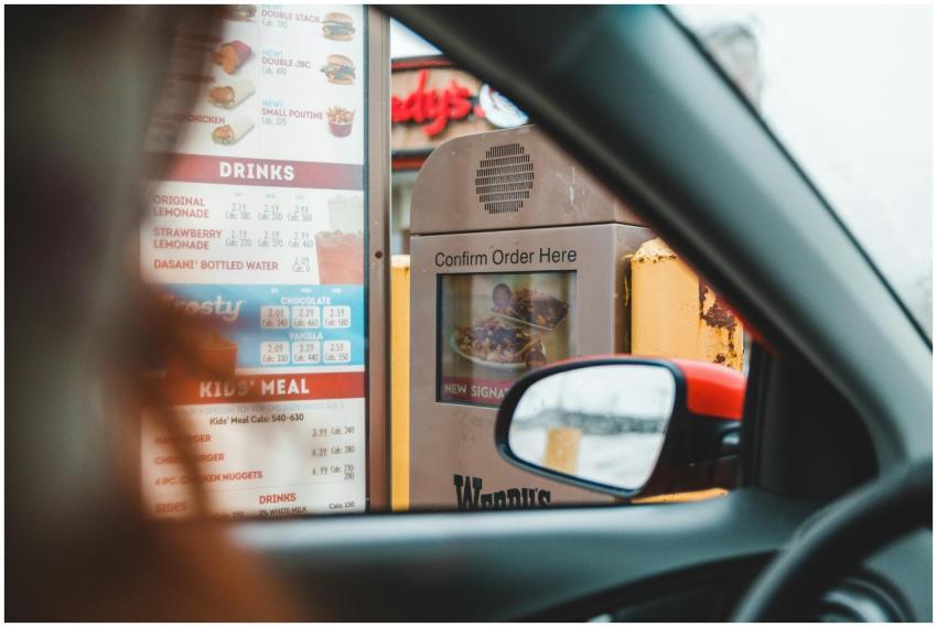 A customer interacts with a drive-thru menu to ord