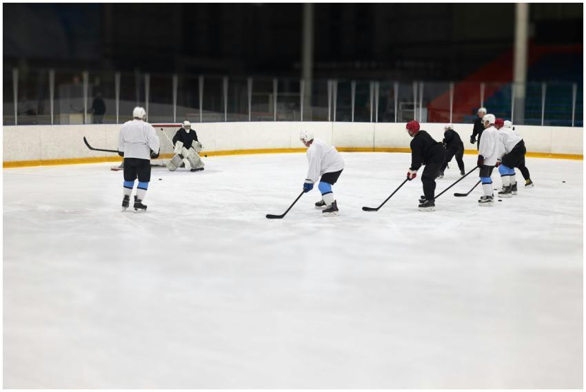 Ice hockey team training indoors, focusing on team