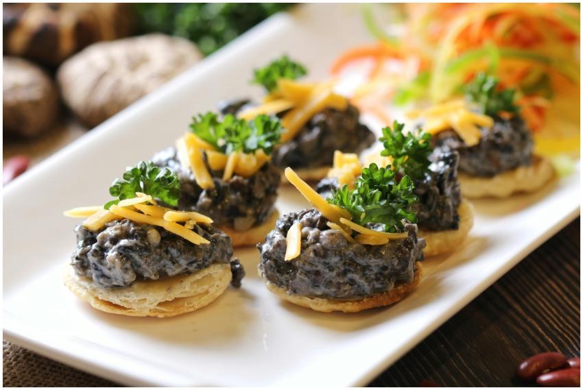 Exquisite canapés topped with grated cheese and pa