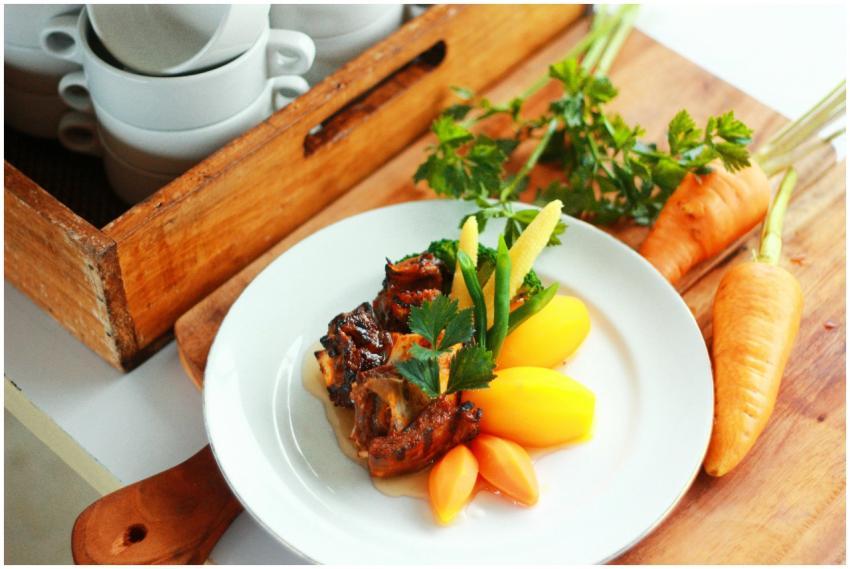 Delicious grilled meat served with carrots and pot