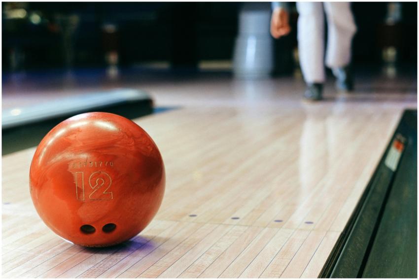 Close-up of a red bowling ball on a bowling alley