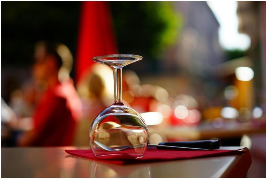 Upside-down wine glass on a vibrant red napkin in