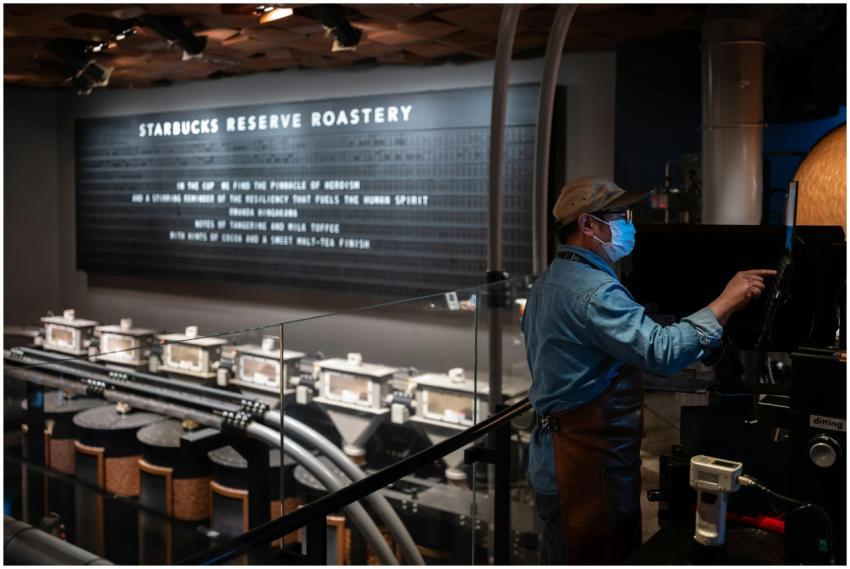 A barista operates machinery at Starbucks Reserve