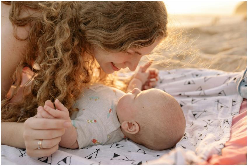 A joyful moment between a mother and baby on a sun