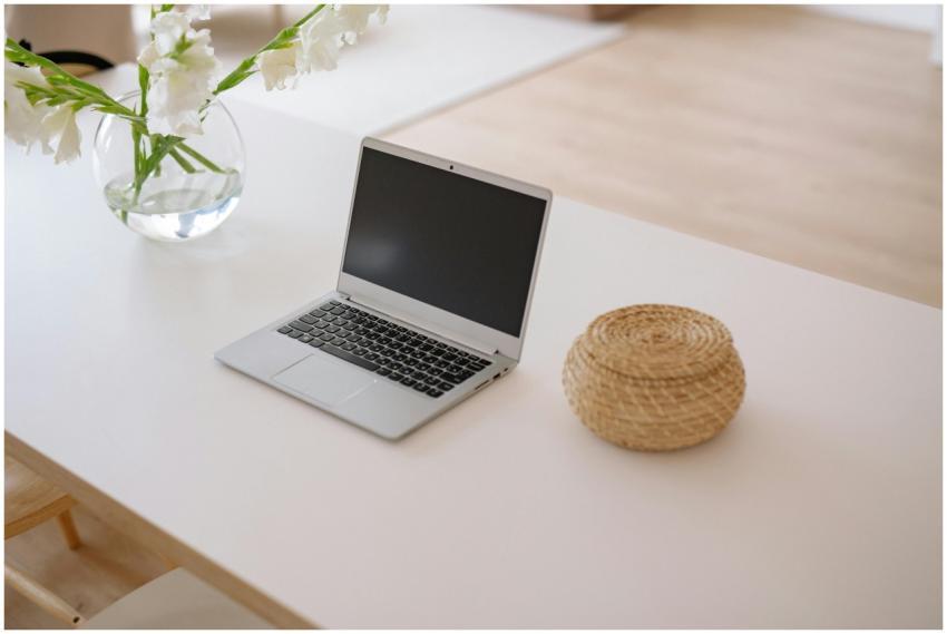 A clean and elegant workspace featuring a laptop,