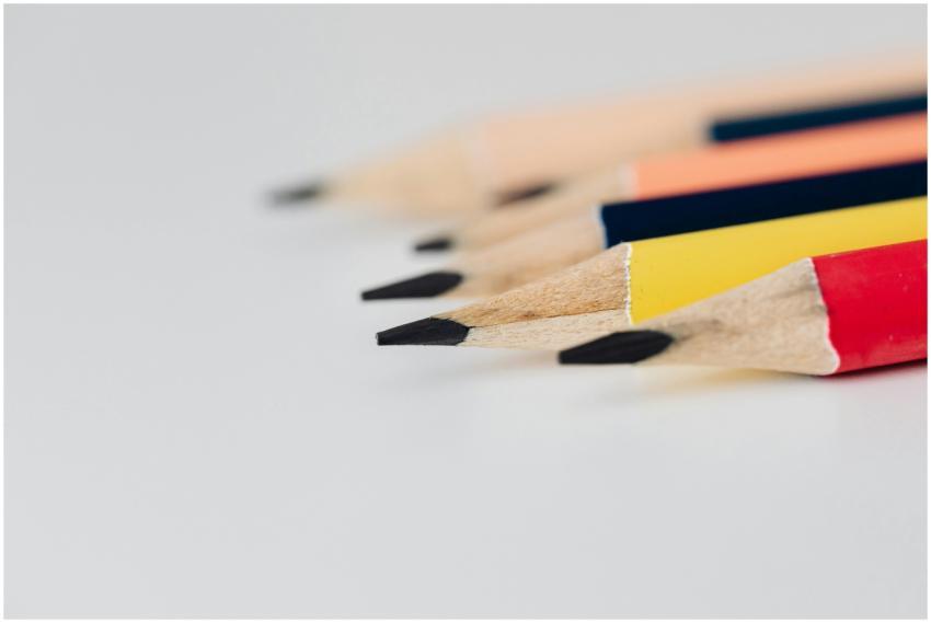 Vivid close-up of sharpened colored pencils on a w