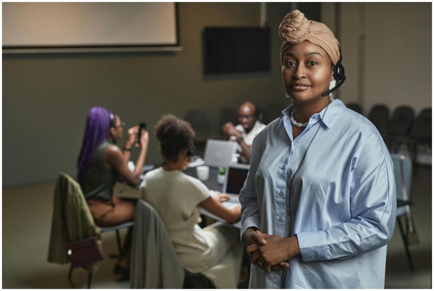 Muslim woman with headset leading a diverse team m