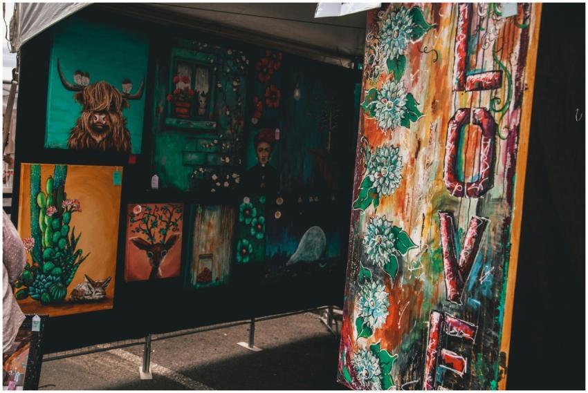 Colorful display of diverse artworks at an outdoor