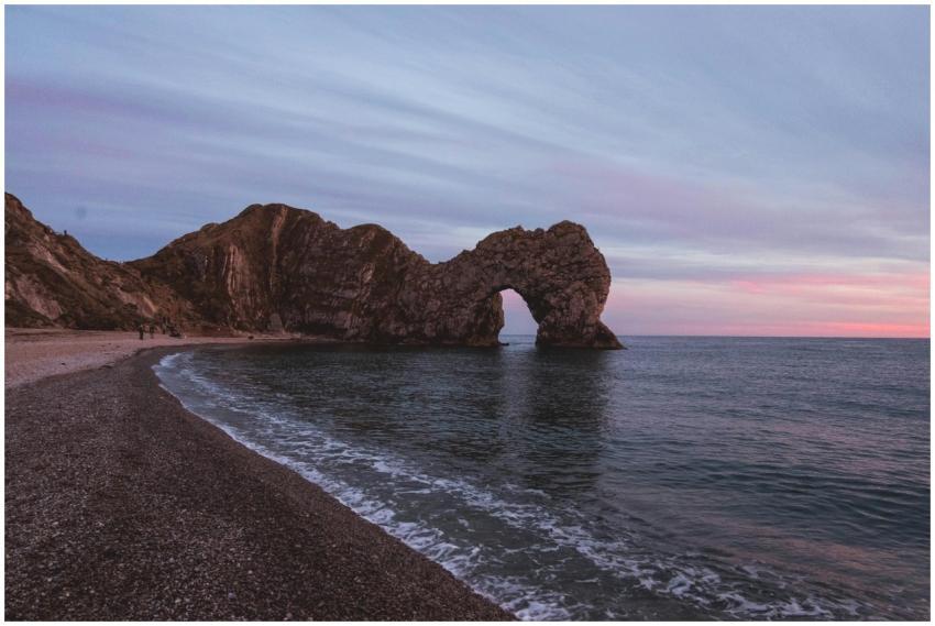 Durdle Door rock formation on Dorset coast at suns