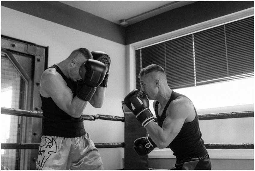 Intense black and white shot of two men sparring i