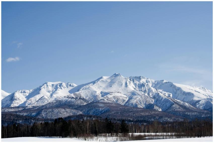 Majestic snowcapped mountains in Hokkaido under a
