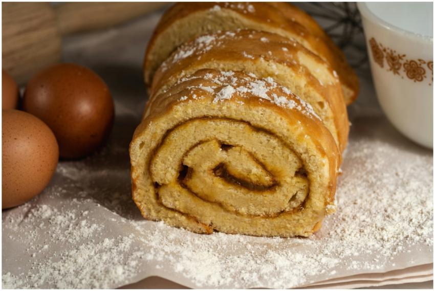 Tasty homemade Swiss roll cake surrounded by eggs