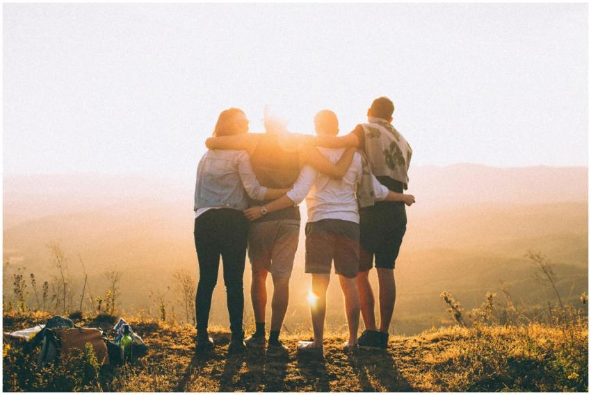 A group of friends embrace while enjoying a breath