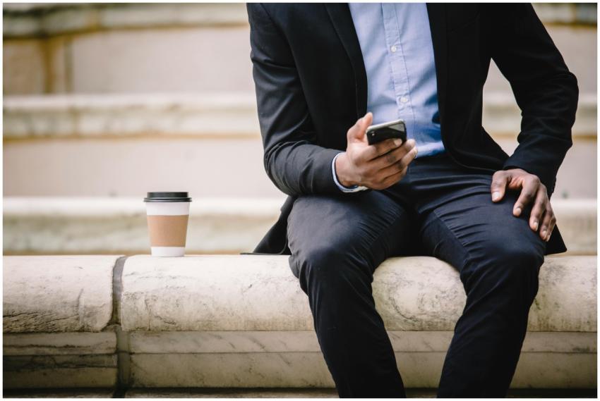 Crop faceless male manager in formal wear sitting
