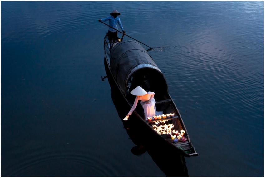 A scenic view of a traditional boat with two peopl