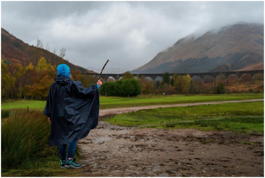 Individual with blue hood in Scottish landscape ne