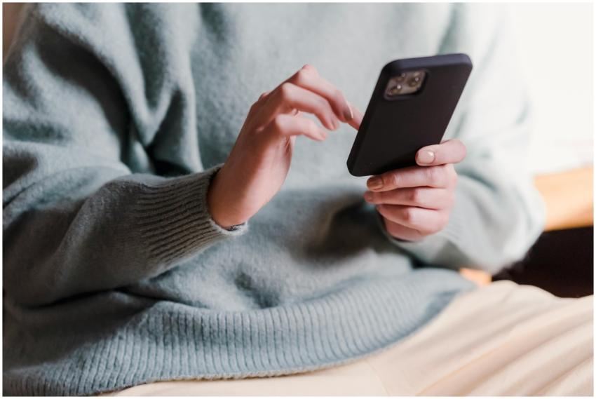 Crop faceless female in casual clothes using smart