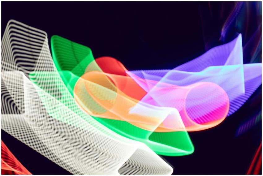 Colorful abstract light trails create a dynamic pa