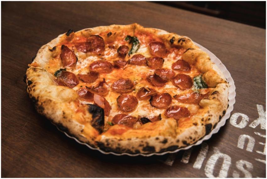 Close-up of a freshly baked pepperoni pizza with c