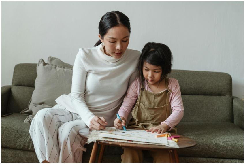 Concentrated little Asian girl in casual clothes s