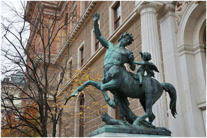 Bronze centaur statue near historic building in Vi