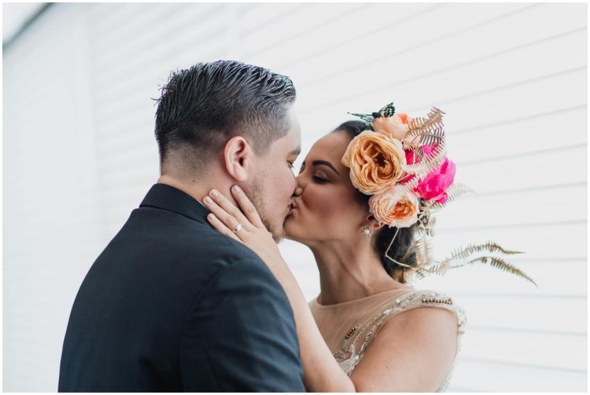 Elegant wedding couple sharing intimate kiss with