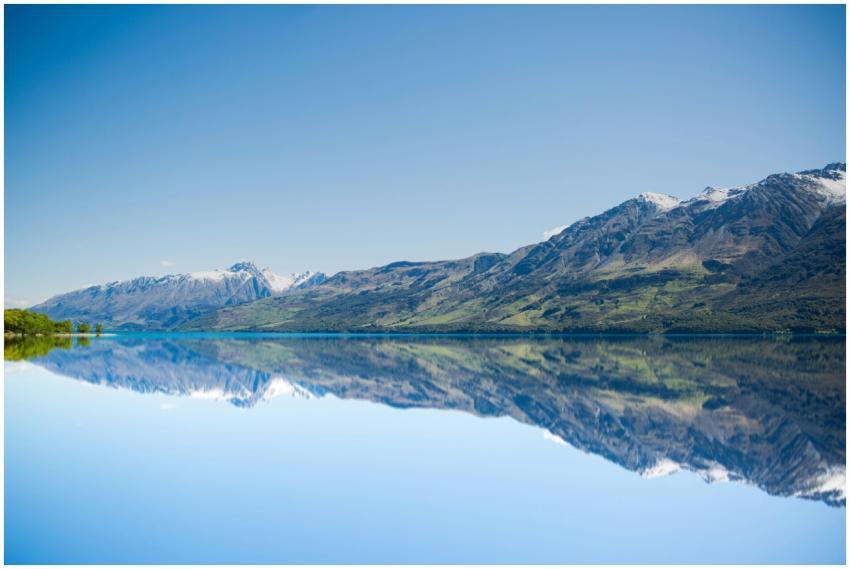 Stunning reflection of mountains on a calm lake un