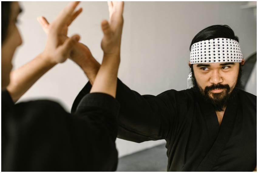 Bearded martial artist practicing self-defense wit