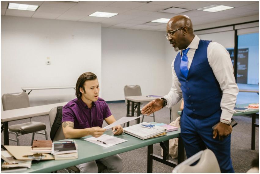 A teacher and student engaged in a discussion over