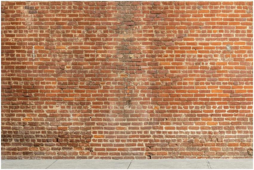 Detailed image of a textured red brick wall with a