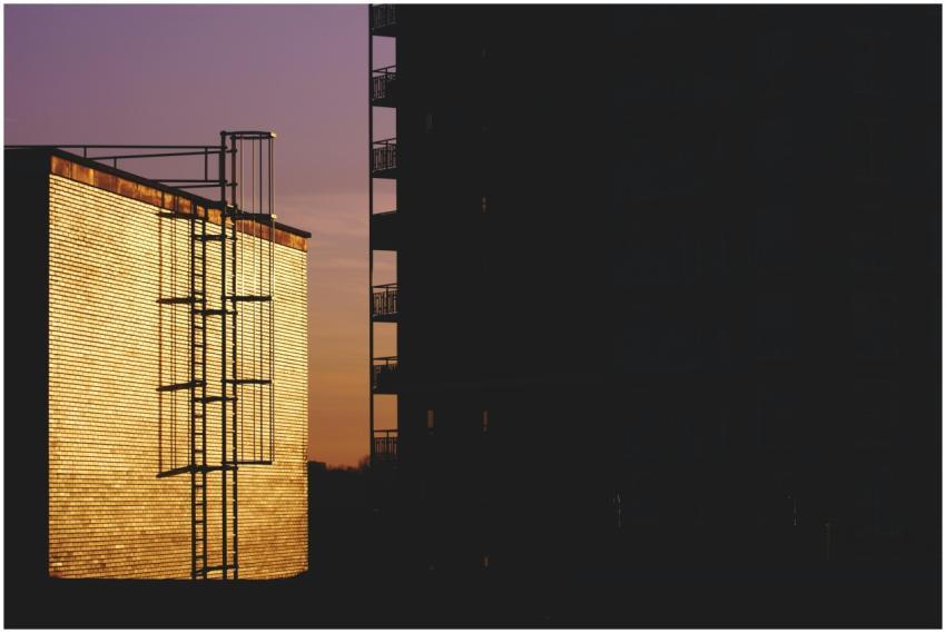 Dramatic sunset view of urban buildings with strik