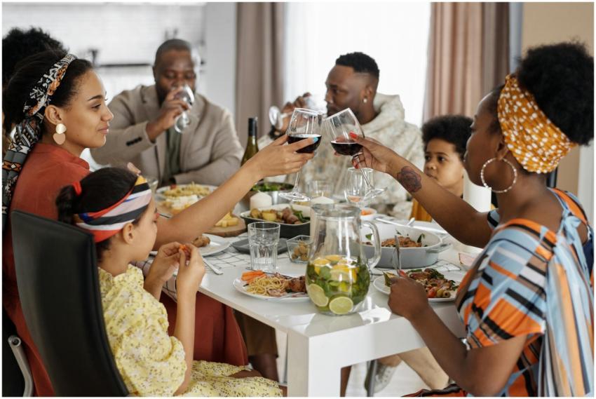 A joyful family gathering sharing a meal indoors,
