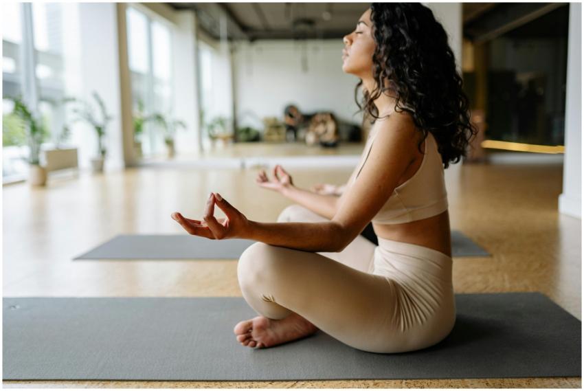 Serene woman practicing yoga meditation in a brigh
