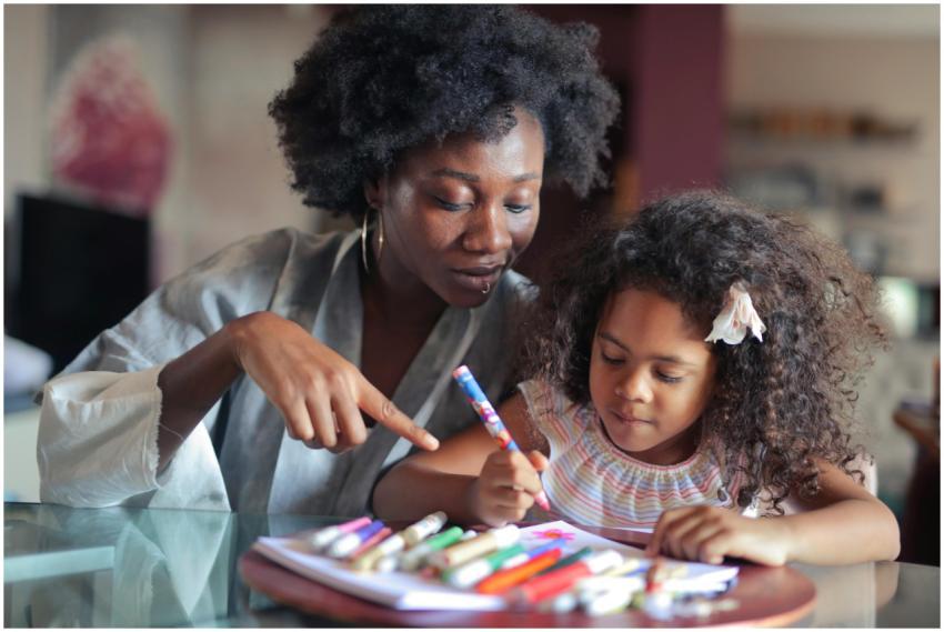 A mother and daughter enjoy quality time coloring