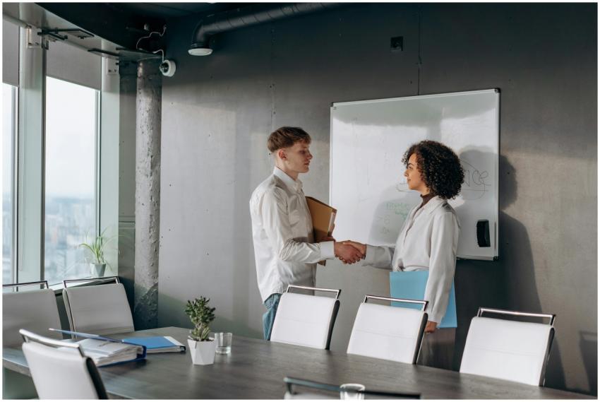 Business colleagues shaking hands in a conference