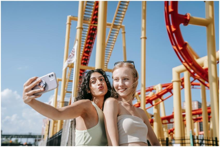 Two young women pose for a selfie in front of a ro