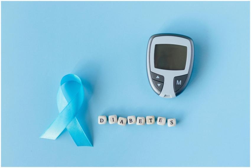 Blue ribbon and glucose meter on blue background h