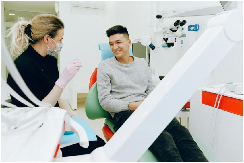A dentist and patient smiling during a dental chec