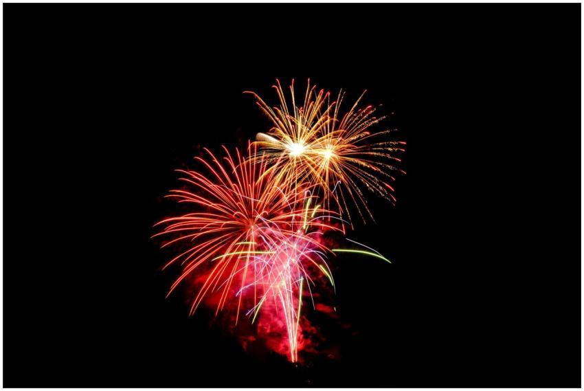 Colorful fireworks exploding in the night sky, per