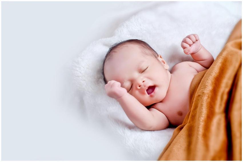 A peaceful sleeping infant wrapped in a soft, warm