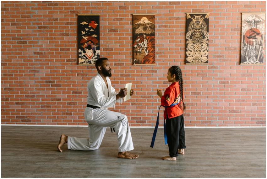 Martial arts instructor training a young student i