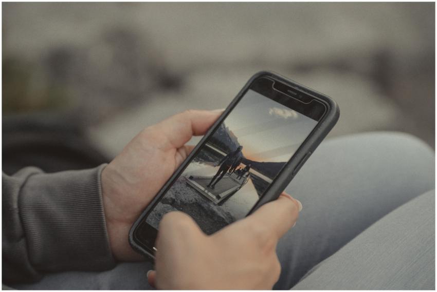 Close-up of hands holding a smartphone showing a m