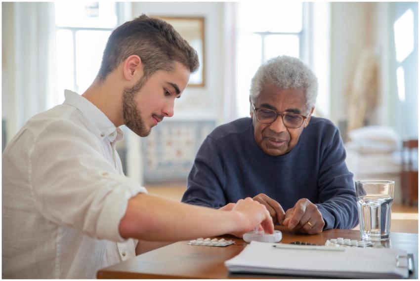A young volunteer helps an elderly man manage his
