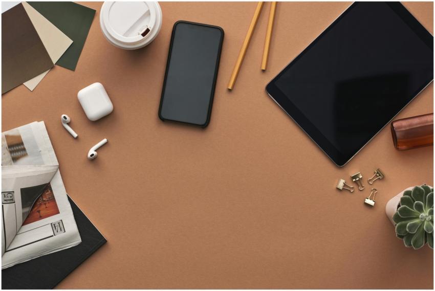 Top view of a stylish workspace with technology ga