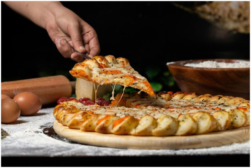 A mouthwatering slice of gourmet pizza being lifte